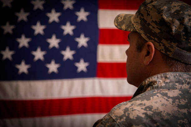 istock USA armed forces military man with American flag. 1041855496