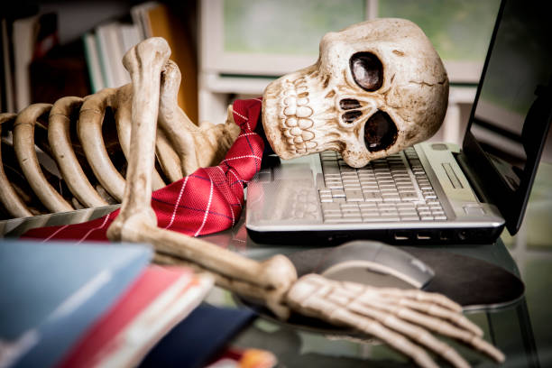 istock Skeleton businessman worked to death in office. 1041860392