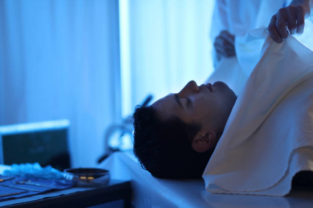 istock Medical Examiner with corpse in morgue. 1041861502