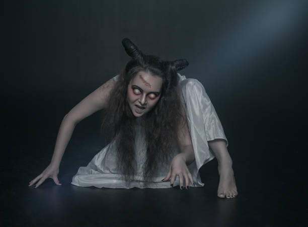 Angel sitting on the stool while white light is shinning above her.