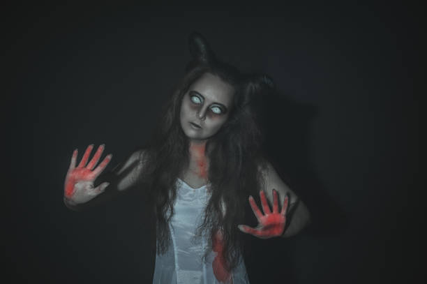 istock Terrible ghost with bloody hands on dark 1041871044