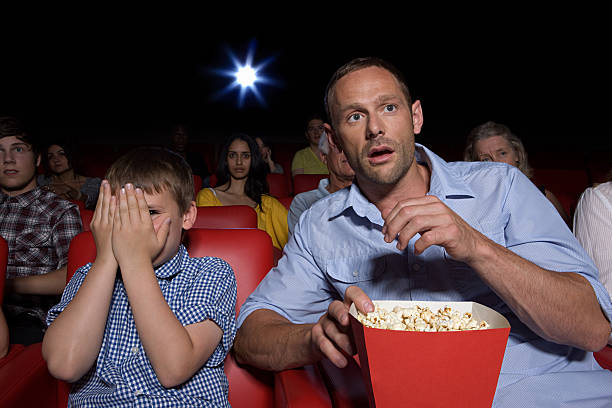 shocked father and son in movie theater - audience surprise movie theater shock 뉴스 사진 이미지