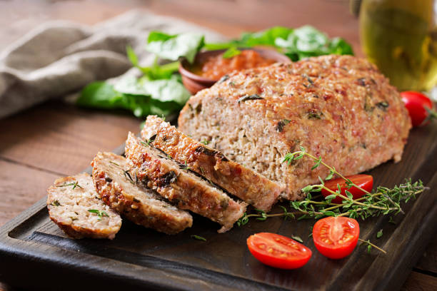 Tasty homemade ground  baked turkey meatloaf on wooden table. Food american meat loaf. stock photo
