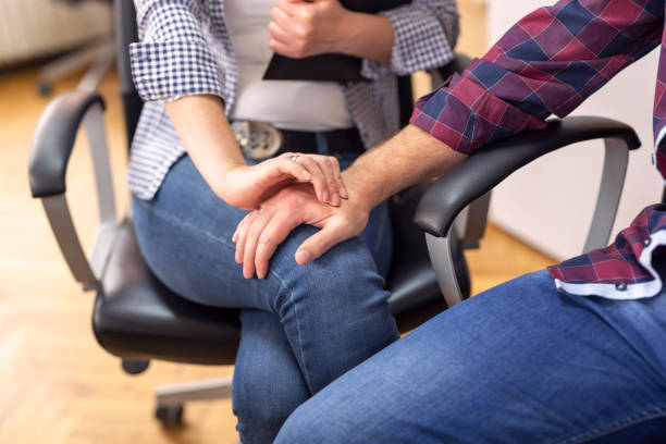 Sexual harassment at work Businessman sexualy harassing female colleague during working hours at a workplace. Selective focus on the woman's fingers standing had to knee pose stock pictures, royalty-free photos & images