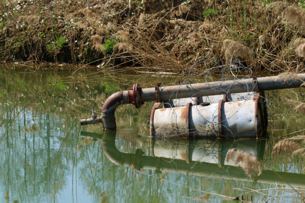 sewage pipe in the lake on floating barrels