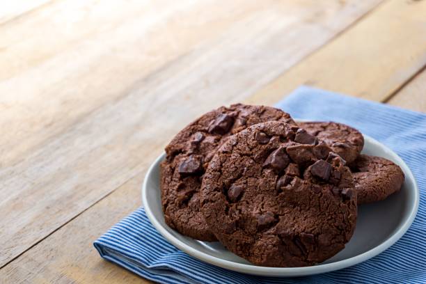 istock Close up image of dark chocolate cookie in white plate 1041886642