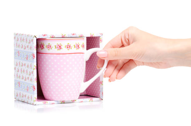 Cup mug vintage pink flower print box in hand on white background isolation