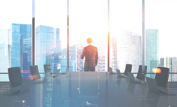 istock Man looking in conference room window 1041893484