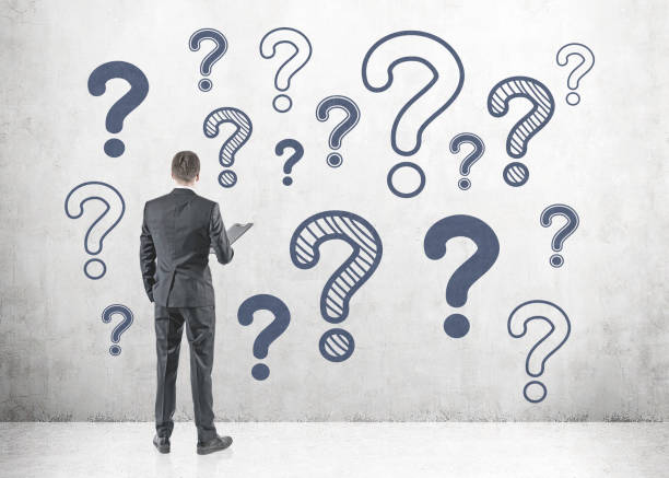 istock Man in suit with folder, rear view many questions 1041899100