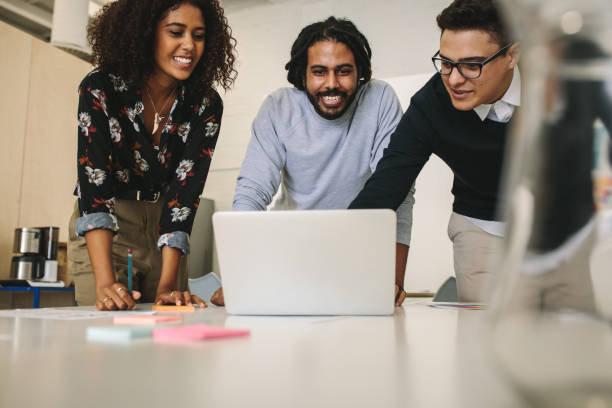 istock Business colleagues discussing work looking at a laptop 1041902462