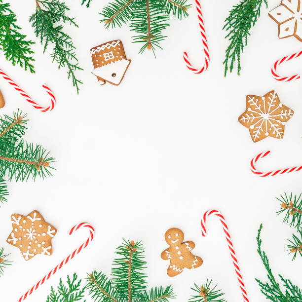istock Round frame made of gingerbread cookies, winter tree and candy cane on white background. Flat lay. top view. Christmas or New year concept 1041903560