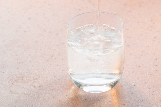 istock natural carbonated water pours in glass 1041904144