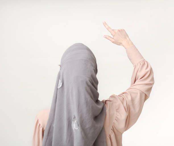 istock Muslim woman pointing on virtual screen, copy space 1041908986