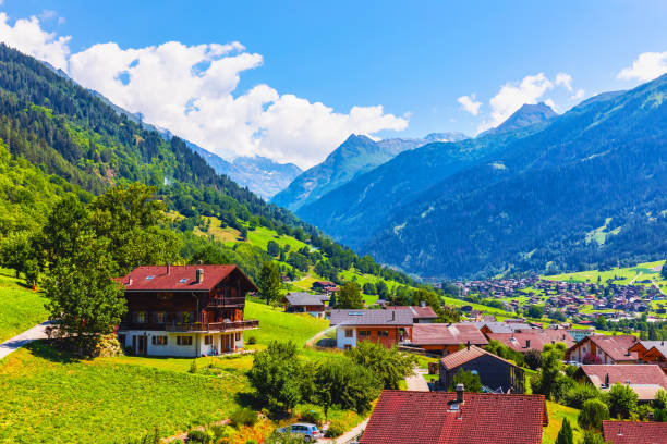 Mountain Village In Alps Switzerland Stock Photo - Download Image