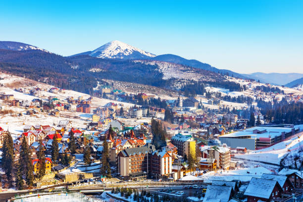 Winter ski resort Bukovel, Ukraine Scenic winter view of mountain ski resort with snowy house cottages with forest and skiing slope in Bukovel, Ukraine carpathian mountain range photos stock pictures, royalty-free photos & images