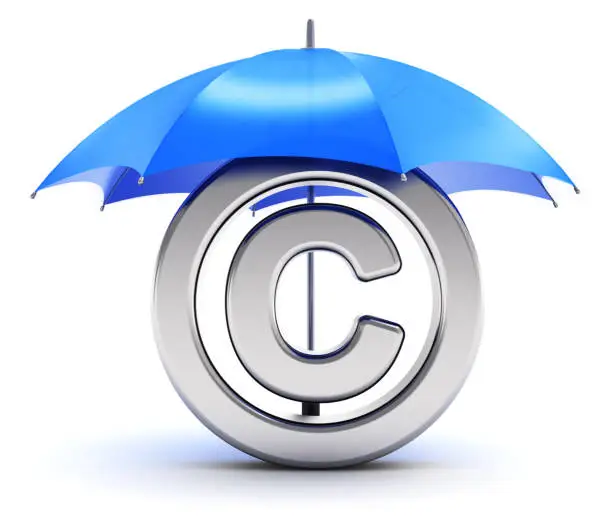 Photo of Silver copyright symbol covered by red umbrella