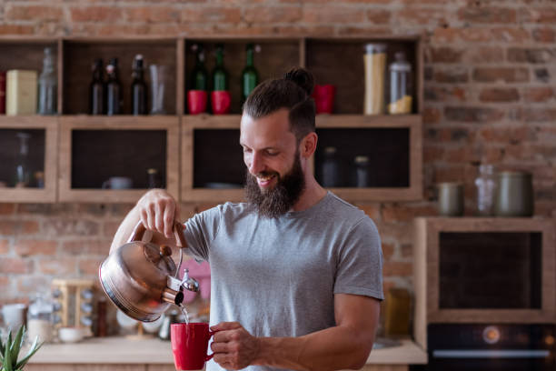 istock hot drink eating habit tea coffee man pour mug 1041919250