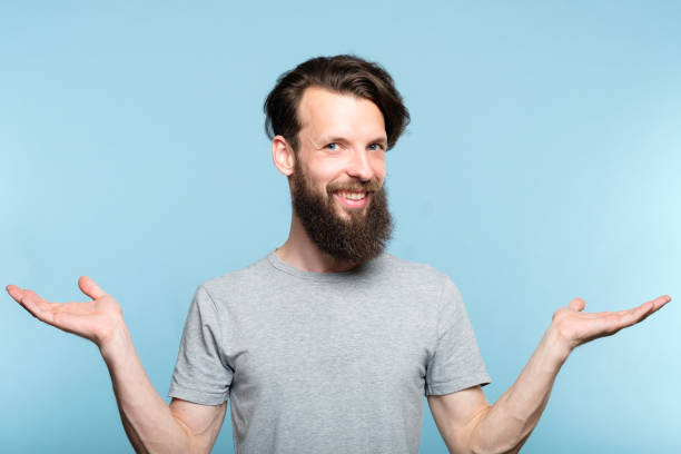 istock smiling hipster man hold hands choice comparison 1041921550