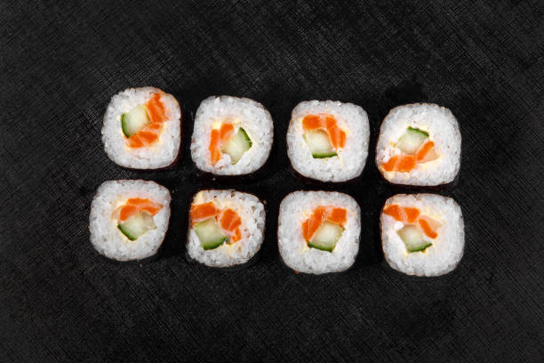 istock Sushi, rolls on a black isolated background 1041924934
