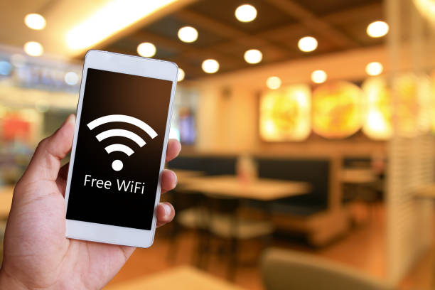 istock Man is holding a white generic smartphone showing free WiFi. 1041925776