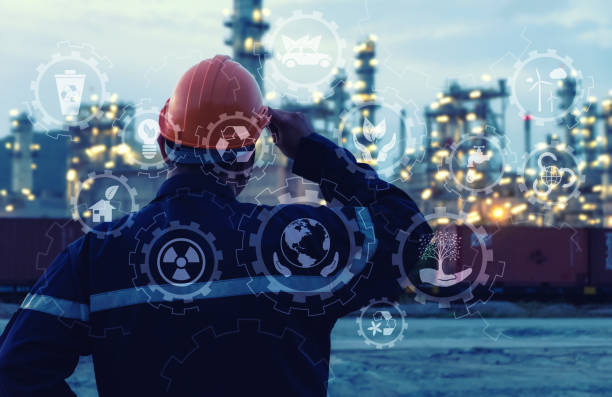 Engineer is standing on large industry background. stock photo