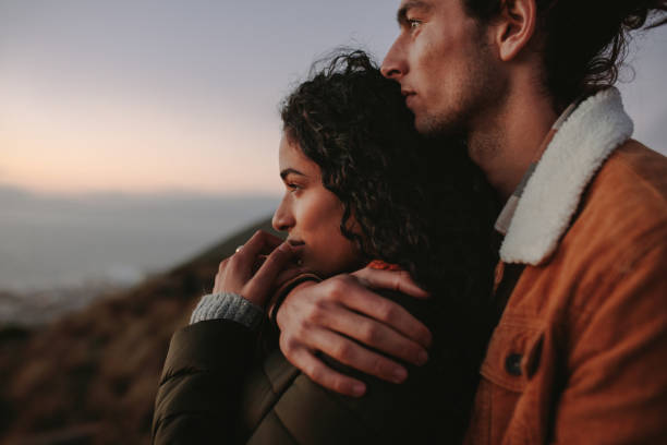 istock Beautiful couple looking at view from mountain 1041926290