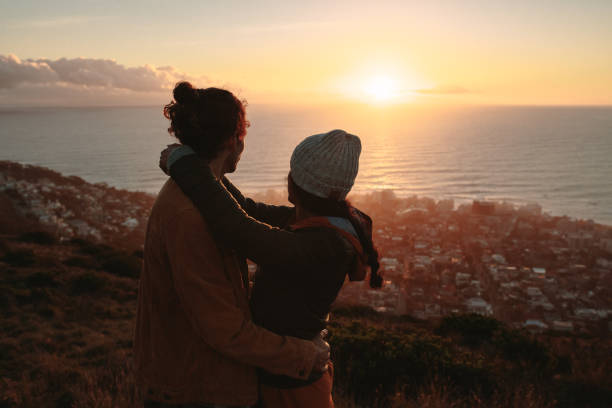 istock Romantic couple admiring the sunset from peak 1041926796