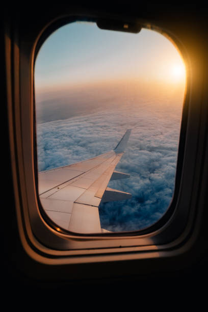 istock Evening airplane flight in twilight sky. Sunset view in cabin frozen window frame 1041930834