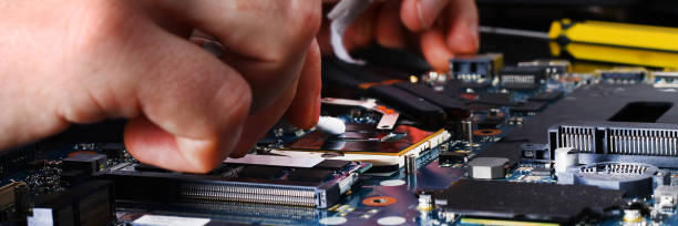 istock Banner. Computer literacy repair men hands, man examines laptop clean thermal paste 1041934648