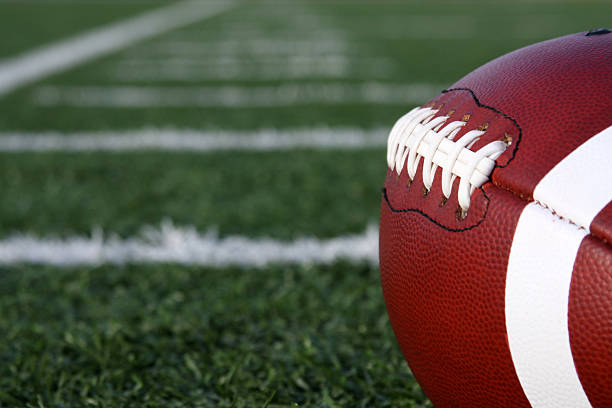 istock Collegiate Football with yard lines beyond 104193849