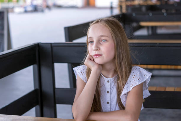 istock Elegant blond model sitting alone at cafe 1041955806
