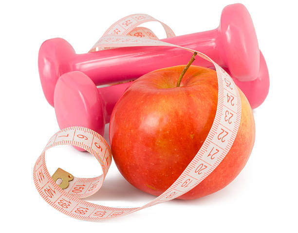 istock two dumbbells, apple and measuring tape 104196114