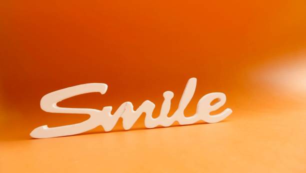 istock Single word Smile on orange background 1041963240