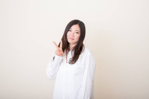 istock young asian woman with peace sign 1041964580