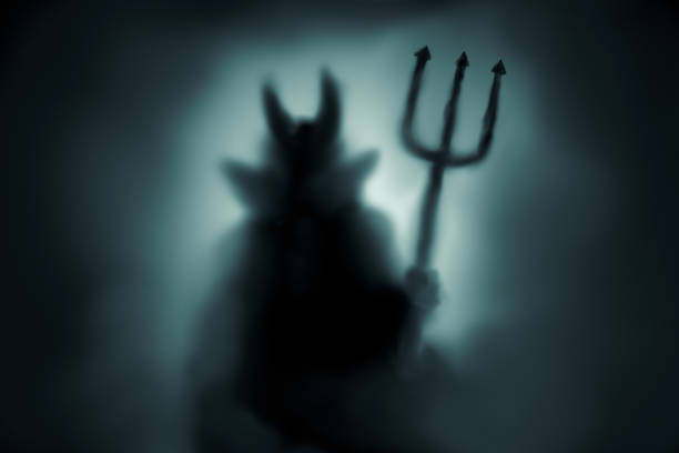 Creepy Devil silhouette Creepy Devil silhouette behind a frozen glass and in the mist with backlit. devil stock pictures, royalty-free photos & images