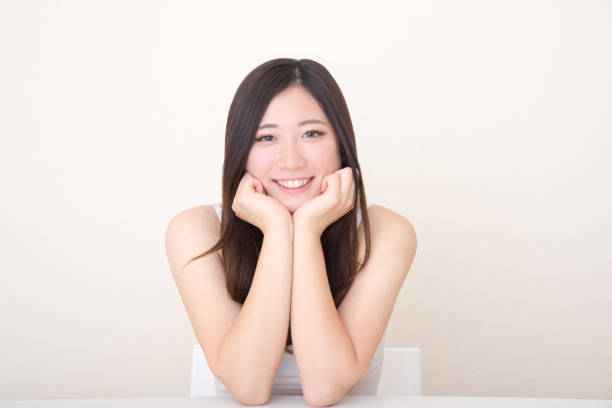 istock young asian woman posing at table 1041972060