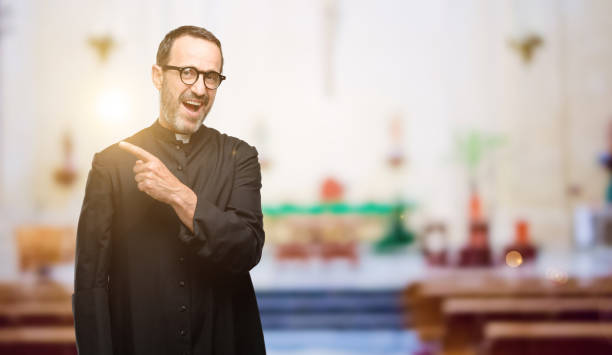 istock Priest religion man pointing away side with finger 1041972322