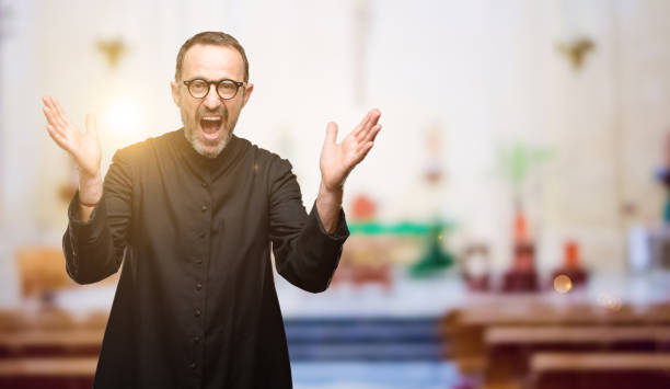 istock Priest religion man happy and surprised cheering expressing wow gesture 1041972352
