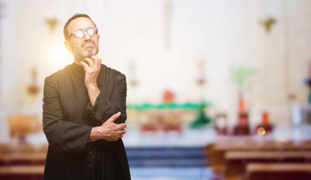 istock Priest religion man thinking and looking up expressing doubt and wonder 1041972396