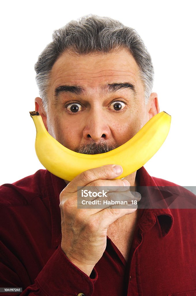 Homem segurar banana a cara, imitating sorriso - Royalty-free 50 Anos Foto de stock