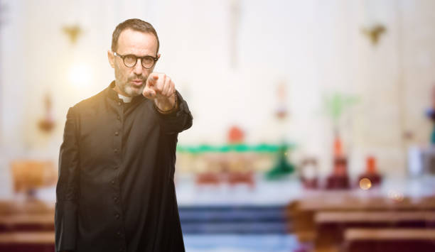 istock Priest religion man pointing to the front with finger 1041972538