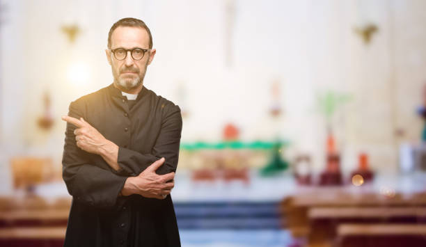 istock Priest religion man pointing away side with finger 1041972602
