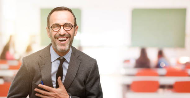 istock Teacher man using glasses confident and happy with a big natural smile laughing 1041972714