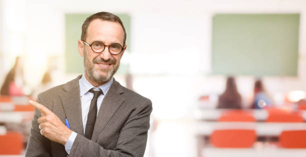 istock Teacher man using glasses pointing away side with finger 1041972978