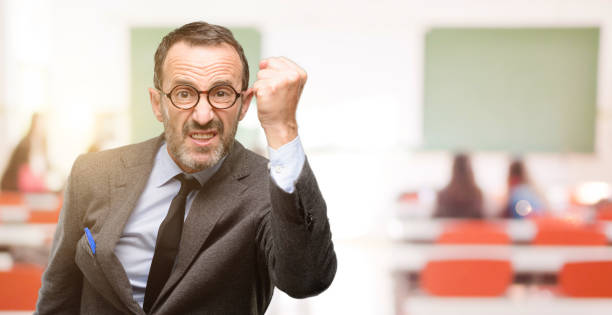 istock Teacher man using glasses irritated and angry expressing negative emotion, annoyed with someone 1041972980