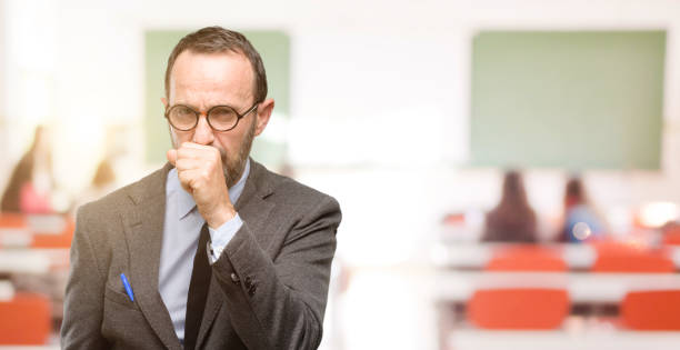 istock Teacher man using glasses sick and coughing, suffering asthma or bronchitis, medicine concept 1041972986