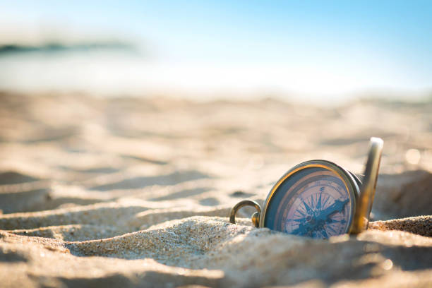 Old vintage compass on the sand beach. . stock photo