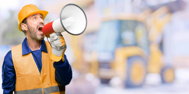 istock Senior engineer man, construction worker communicates shouting loud holding a megaphone, expressing success and positive concept, idea for marketing or sales 1041975862