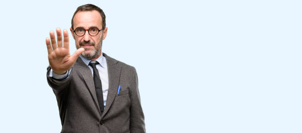 istock Teacher man using glasses annoyed with bad attitude making stop sign with hand, saying no, expressing security, defense or restriction, maybe pushing 1041976742