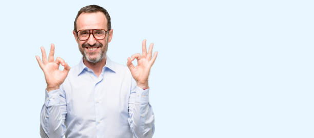 istock Middle age man with glasses doing ok sign gesture with both hands expressing meditation and relaxation 1041977168